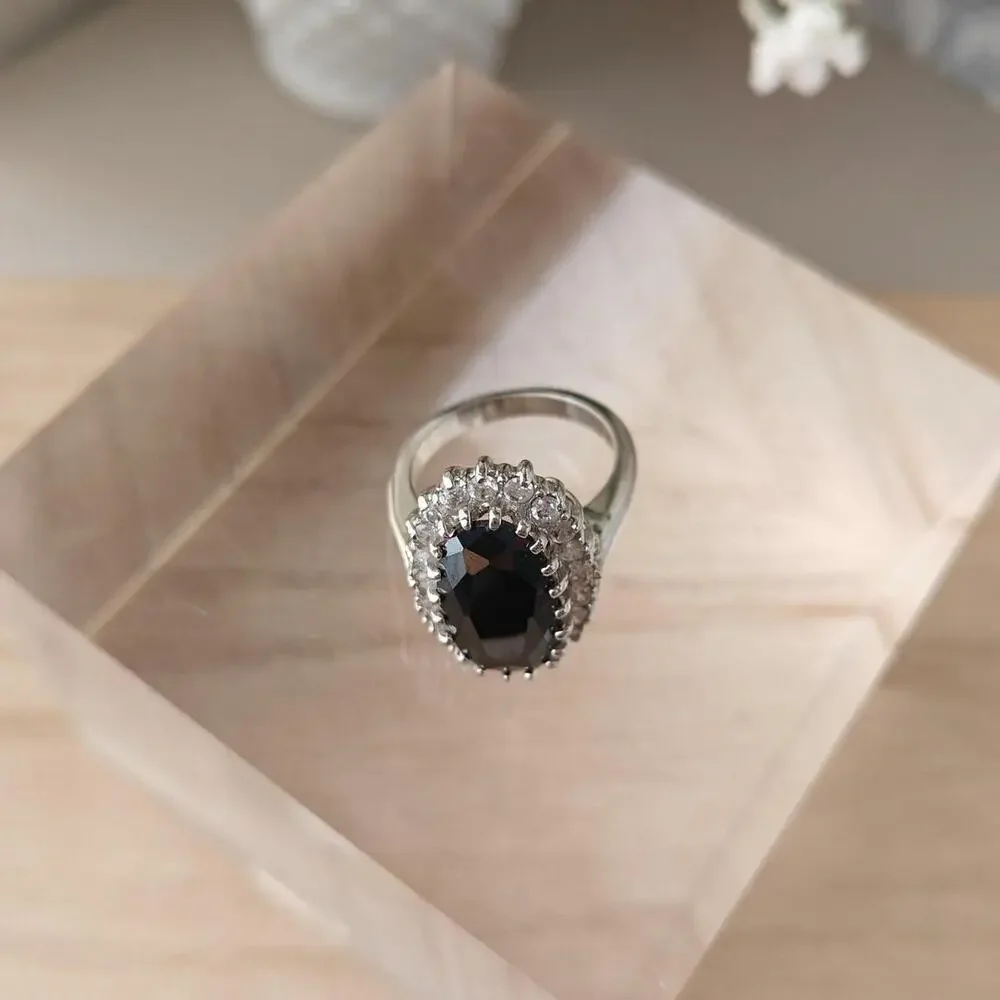 Silver tone oval black glass halo ring with white rhinestones